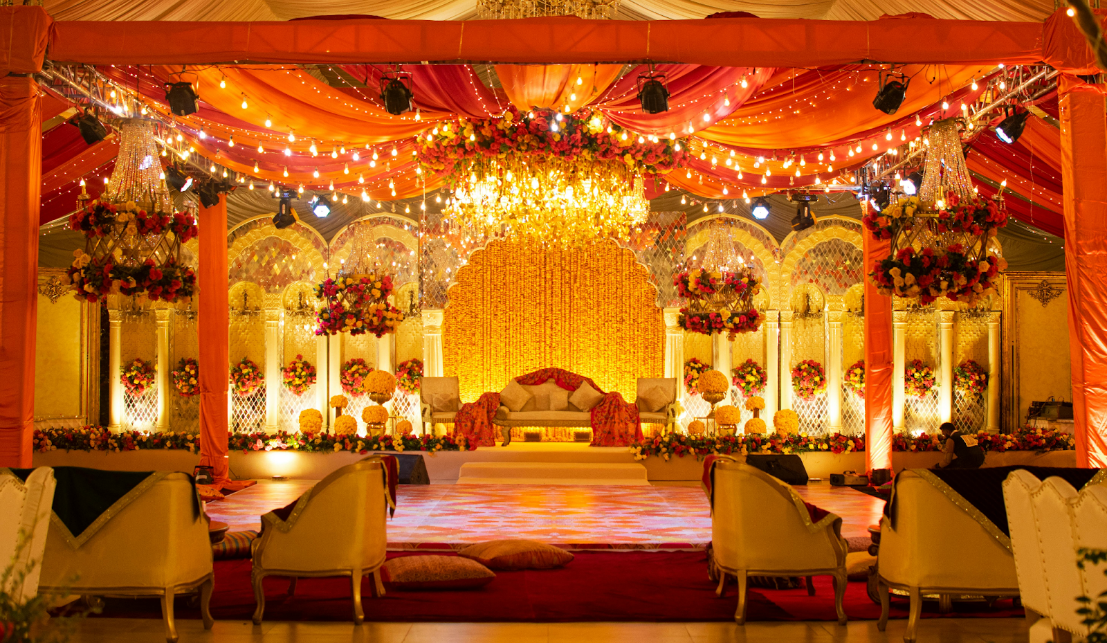 Elegant Indian wedding mandap in New York showcasing trending color themes with floral and fabric decor elements, blending tradition and modern design.