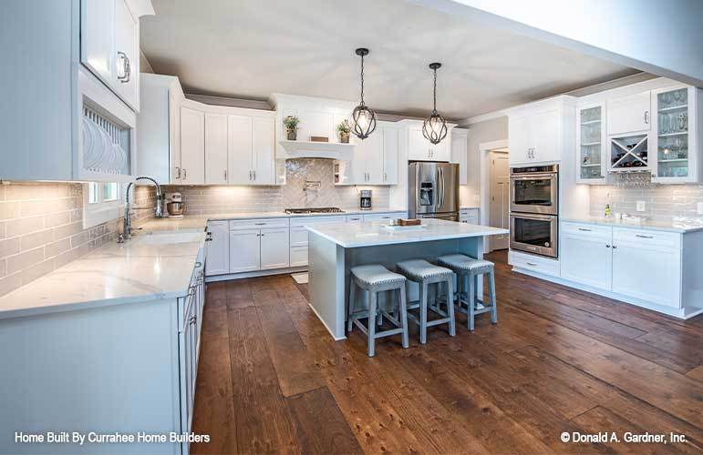 Stainless steel appliances, a farmhouse sink, and a built-in wine rack complete the kitchen.Stainless steel appliances, a farmhouse sink, and a built-in wine rack complete the kitchen.