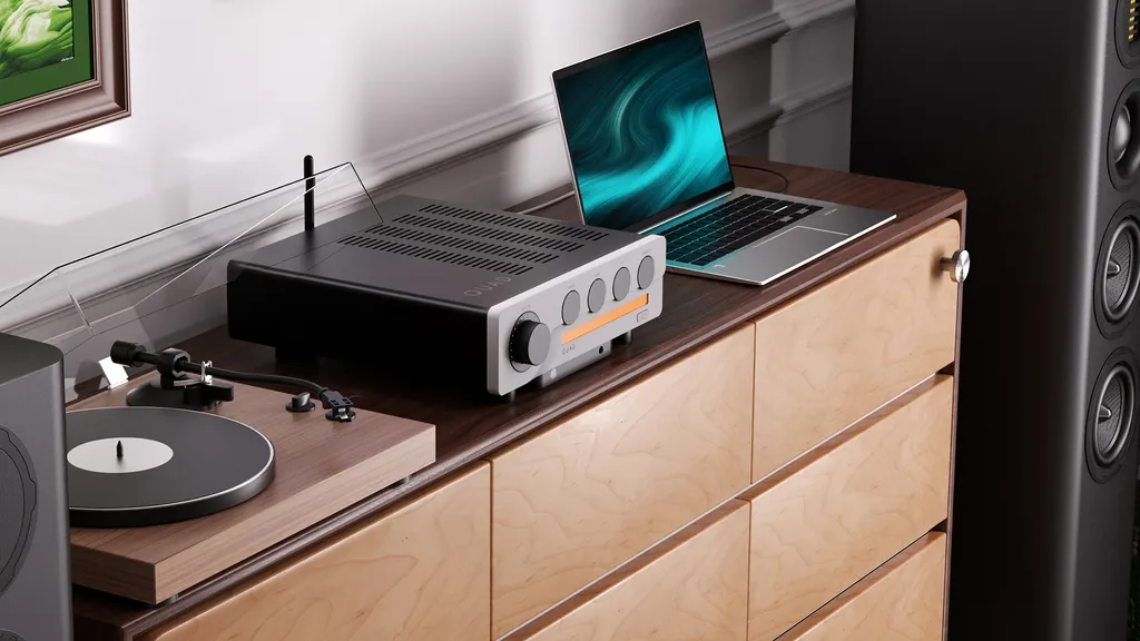 Quad 3 integrated amplifier next to turntable and laptop.
