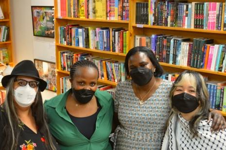 A group of women wearing masks in a library

Description automatically generated