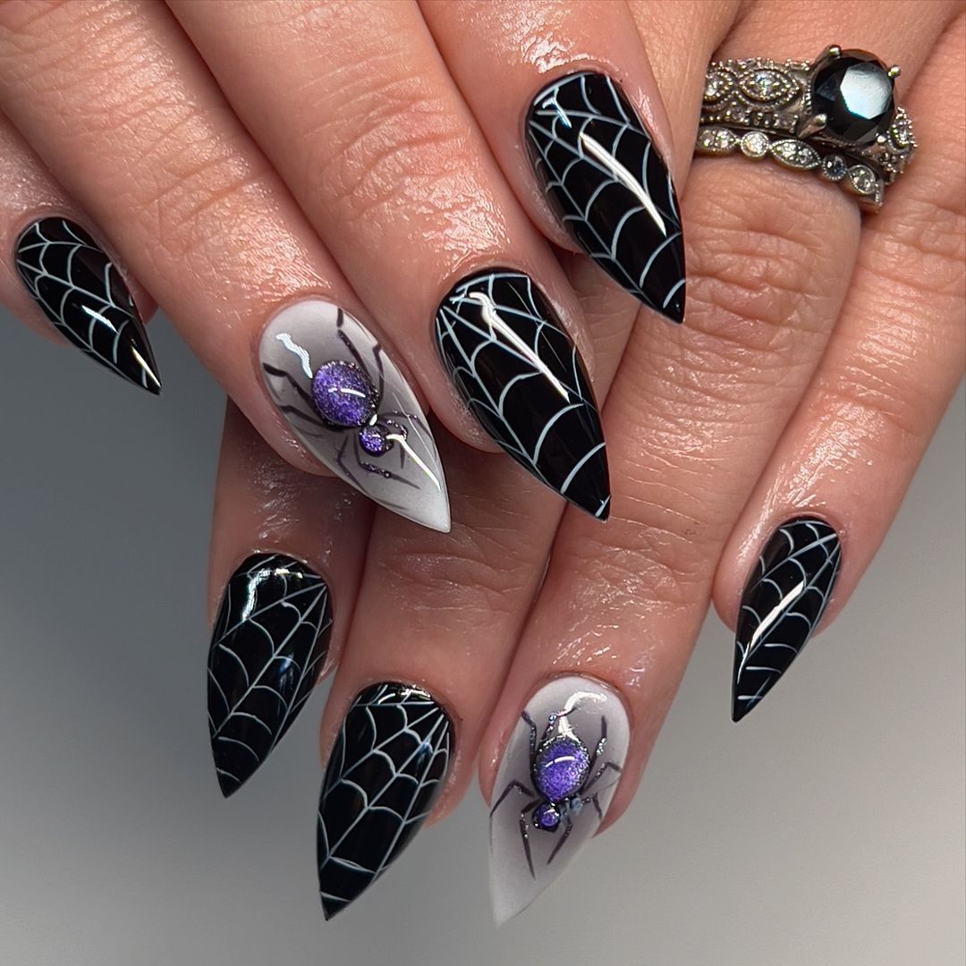 Close-up of a person's hands with black nails having Spiderweb Designs