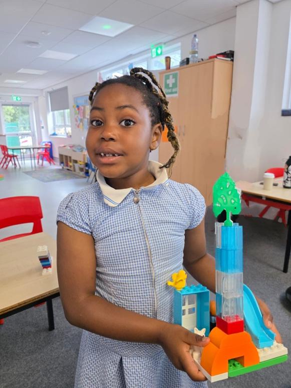 A child holding a building toy

Description automatically generated
