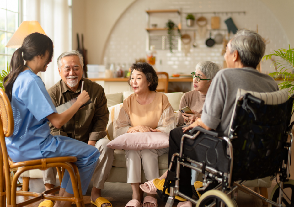 A family of four sitting together with a nurse, discussing whether memory care might be an option.