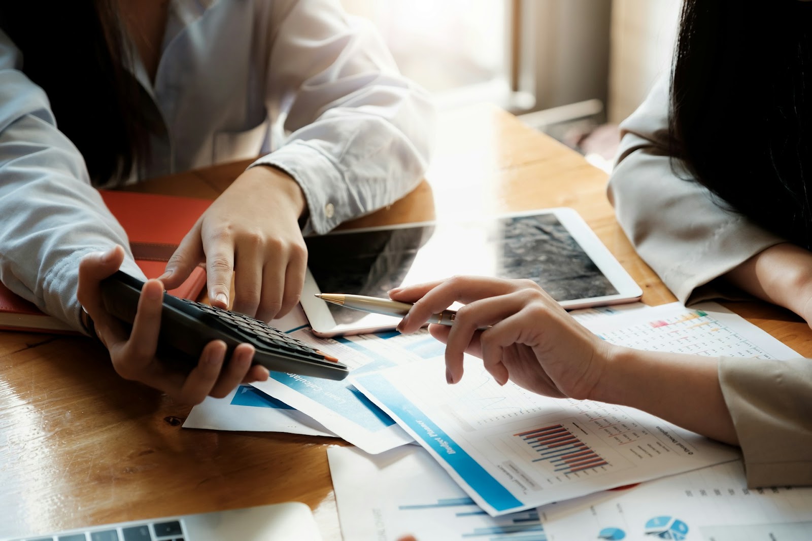 A man and a woman sit down going through paperwork to manage their investment