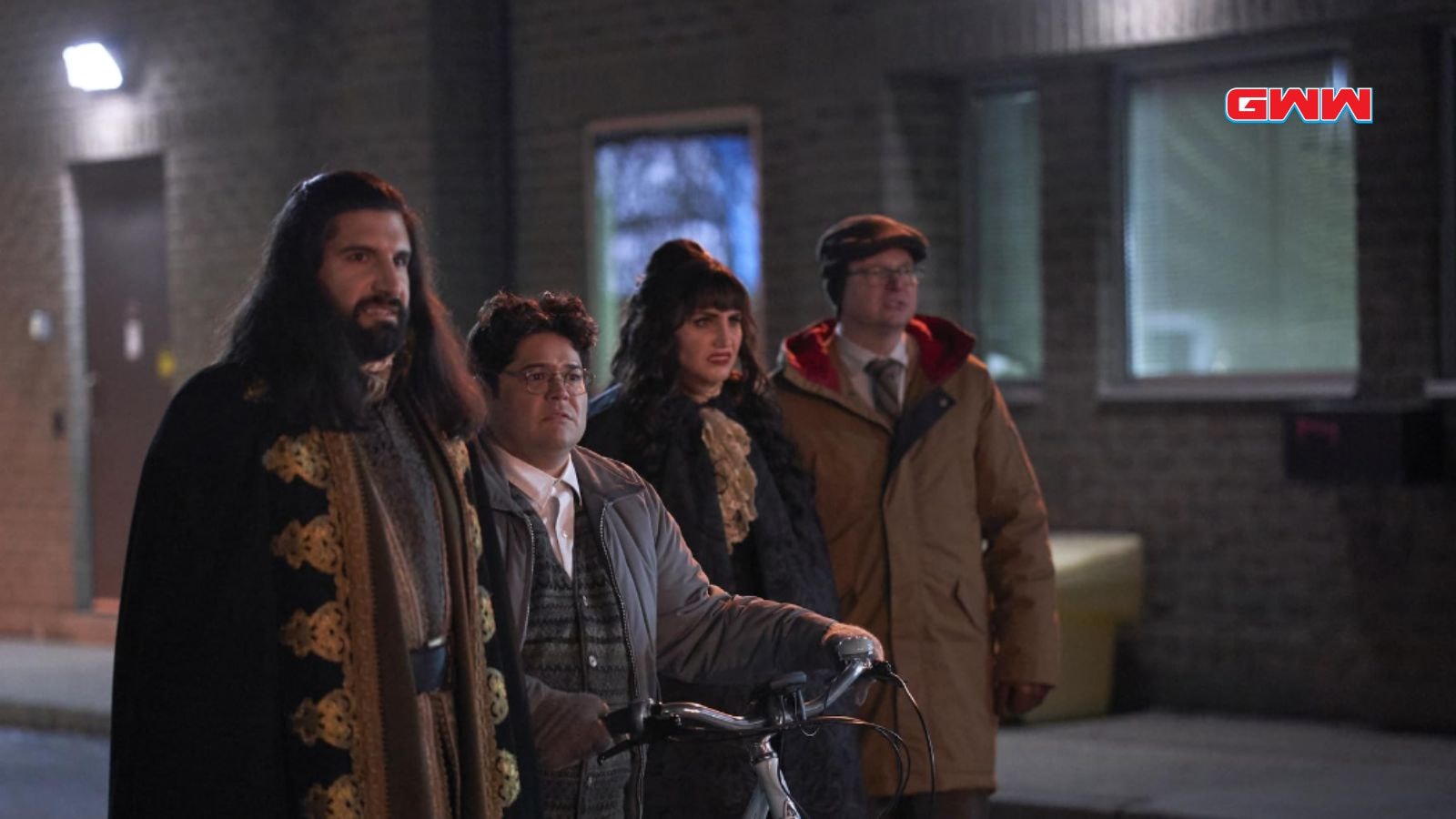 Nandor, Guillermo, Nadja, and Colin standing outside at night, looking determined.