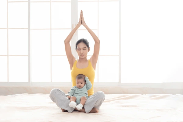 a mom doing yoga with her baby