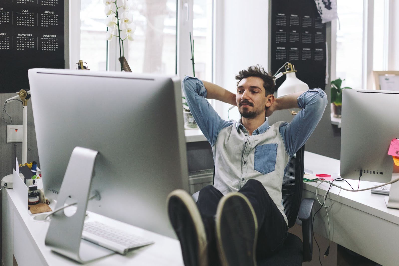 A smiling programmer working at a clean, organized desk, showing a productive and distraction-free vibe coding environment.