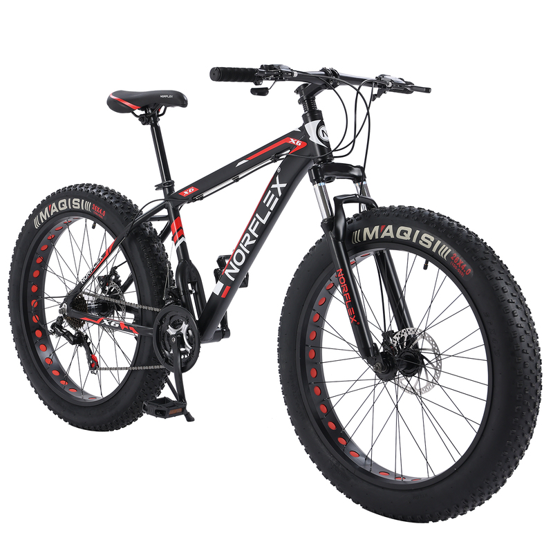 A black and red mountain bike with thick, knobby tires and a sturdy frame, designed for off-road trails, highlighting the difference in design between a mountain bike vs. racing bike. This mountain bike features disc brakes and wide handlebars, making it suitable for rough terrain.