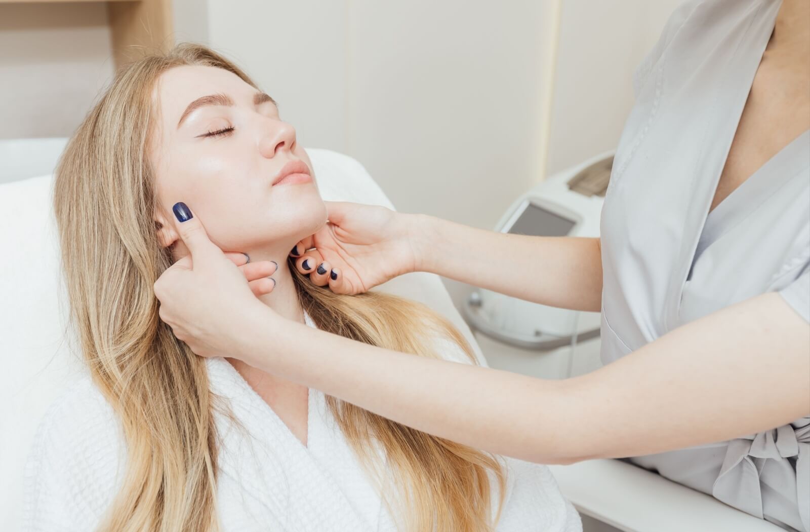 An esthetician examines a person's rejuvenated skin after radiofrequency treatment.