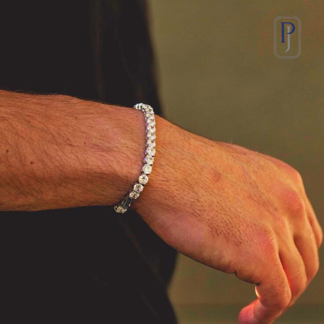 A charming lab-grown diamond bracelet in white gold on the wrist of a man with secured clips.