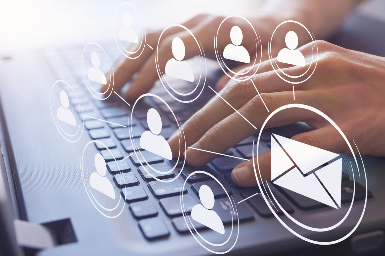 Hands typing on laptop with digital email and user icons overlay.