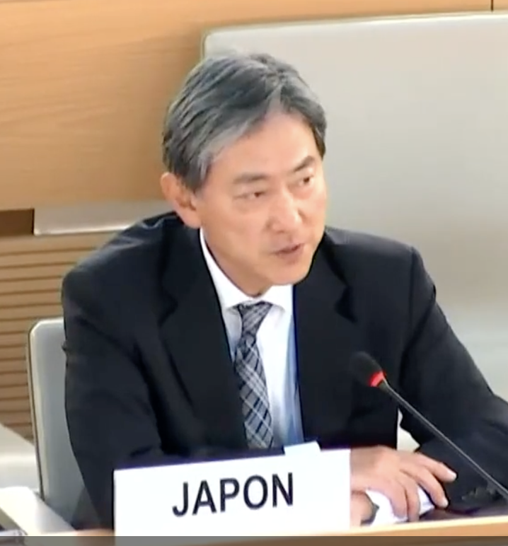 A person in a suit speaking into a microphone

AI-generated content may be incorrect.