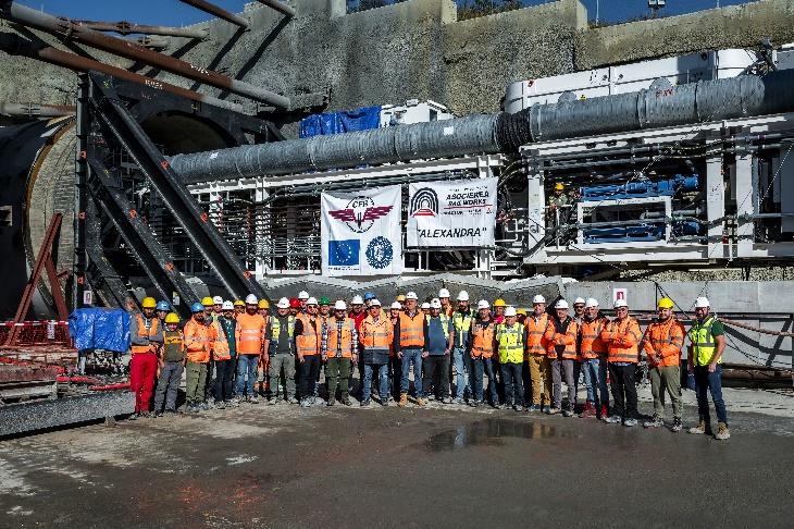 A group of people in orange vests and helmets  Description automatically generated