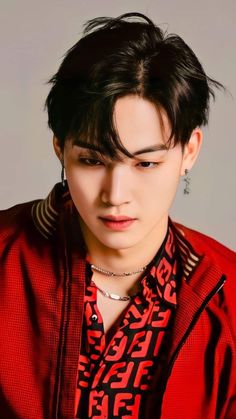 This contains an image of GOT7's Jay B   with a black hair wearing a red shirt and silver earring necklaces