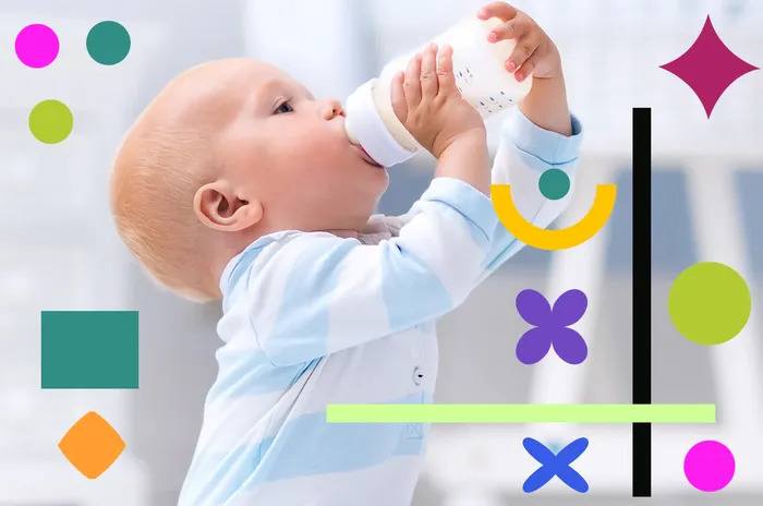 A baby holds a bottle featuring vibrant shapes, happily drinking from it in a cozy setting.
