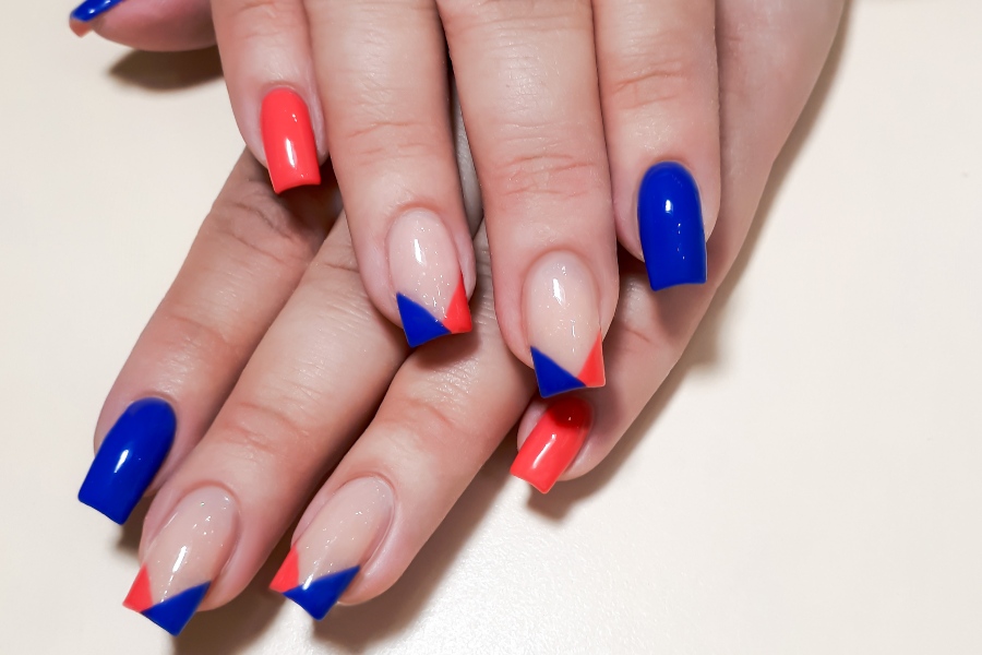 Chevron tips add a sharp, geometric flair to a modern French nail tip design.