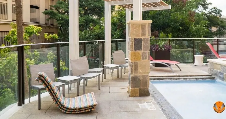 A glass railing system around the pool at a hotel. 