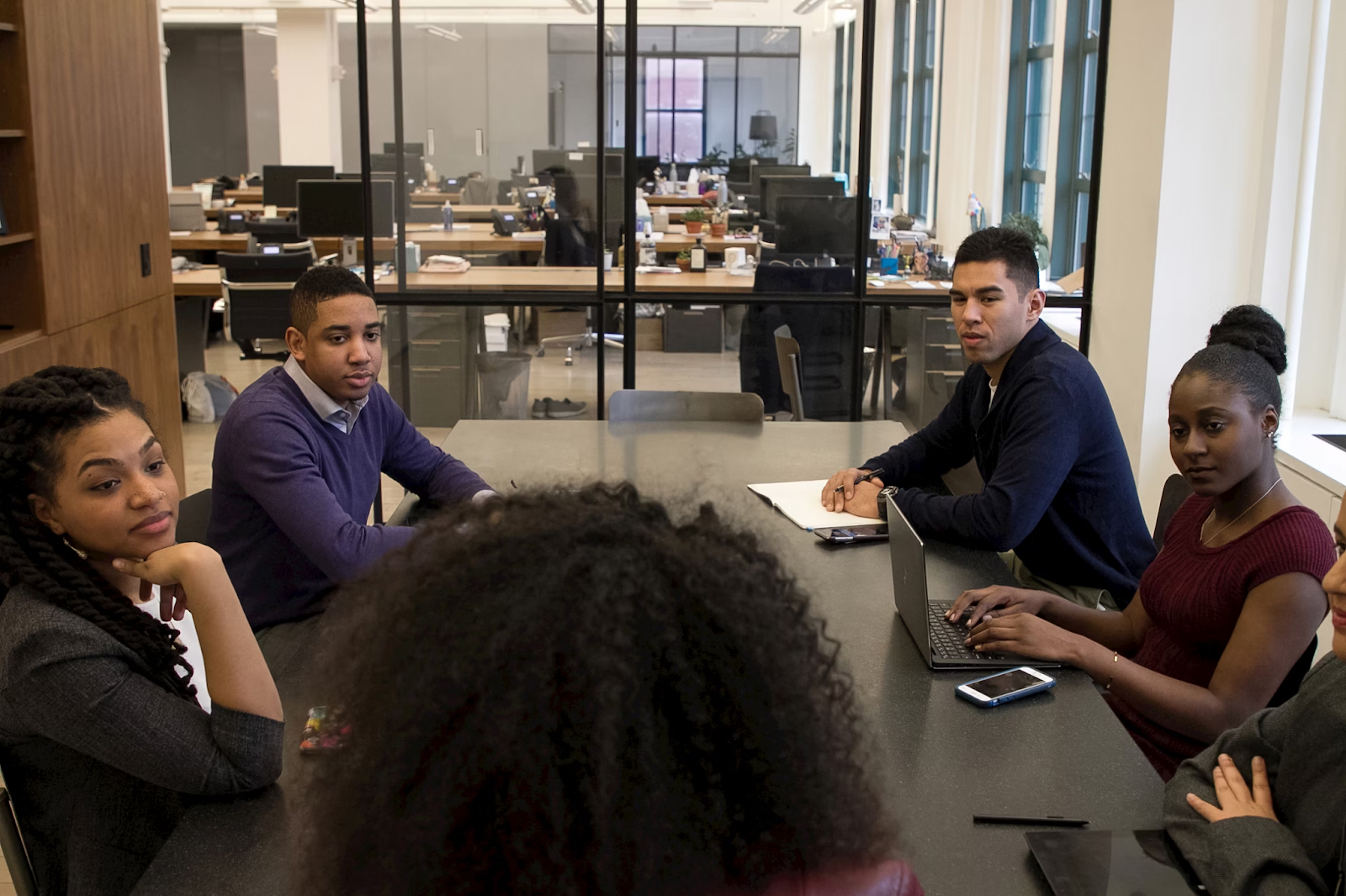 rear view of a businesswoman yelling at her team in an office boardroom, highlighting warning signs of a toxic workplace culture and when to quit your job