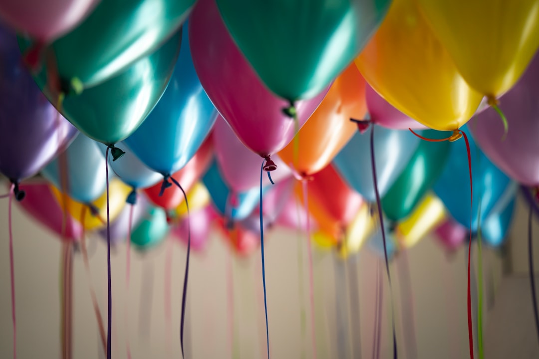Teenager holding birthday balloons