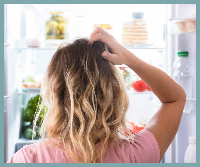 A person looking at a refrigerator

Description automatically generated