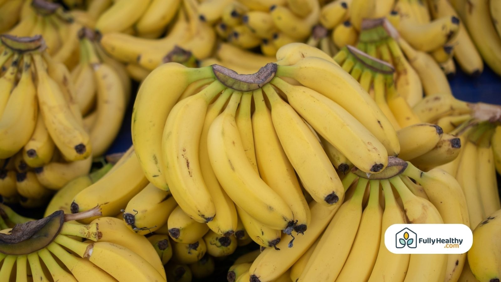 Large banana bunches displayed at a market stall