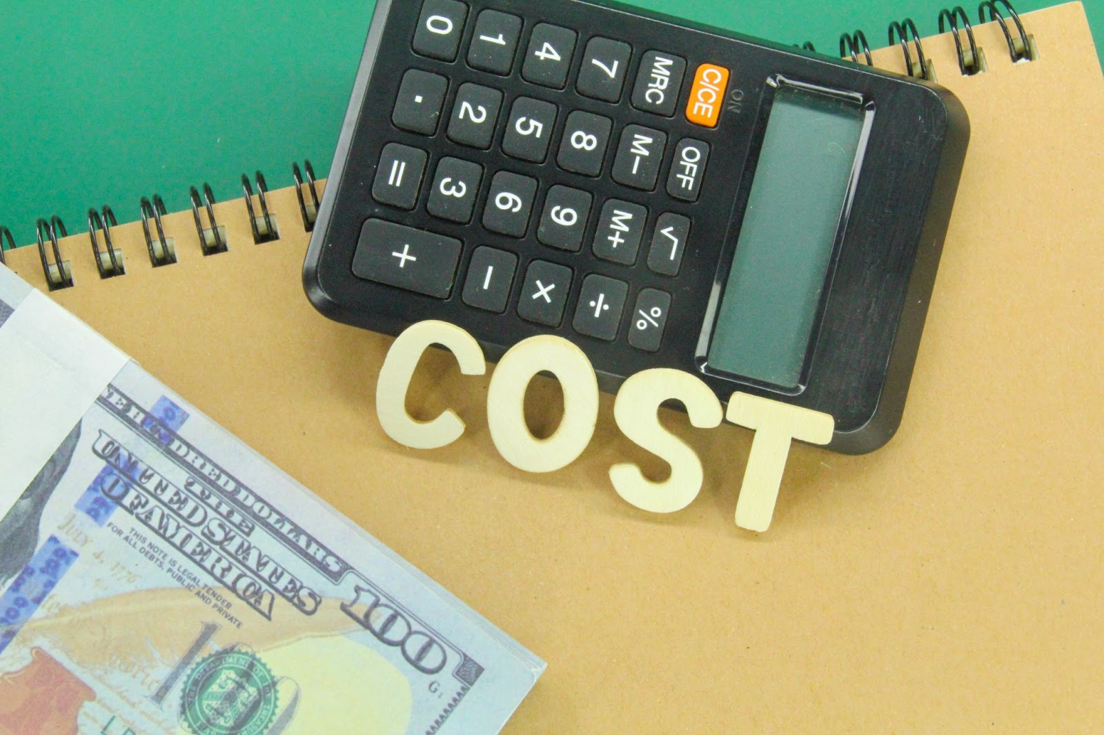 Word “cost” next to money and a calculator. 