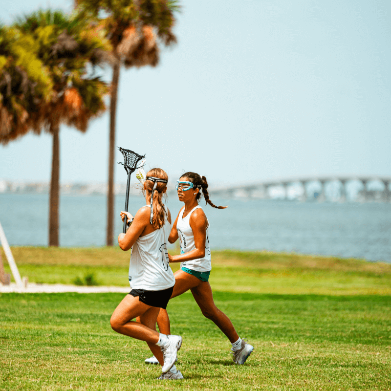 Girls on the lacrosse field during practice at overnight sports camp