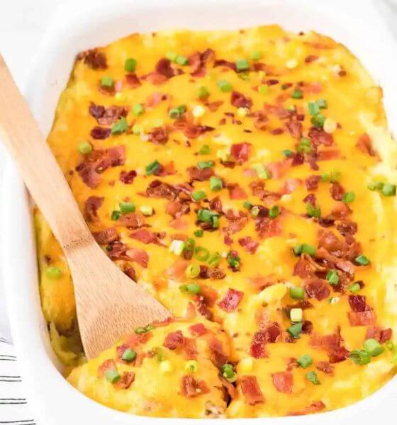 Loaded mashed potato casserole in white baking dish