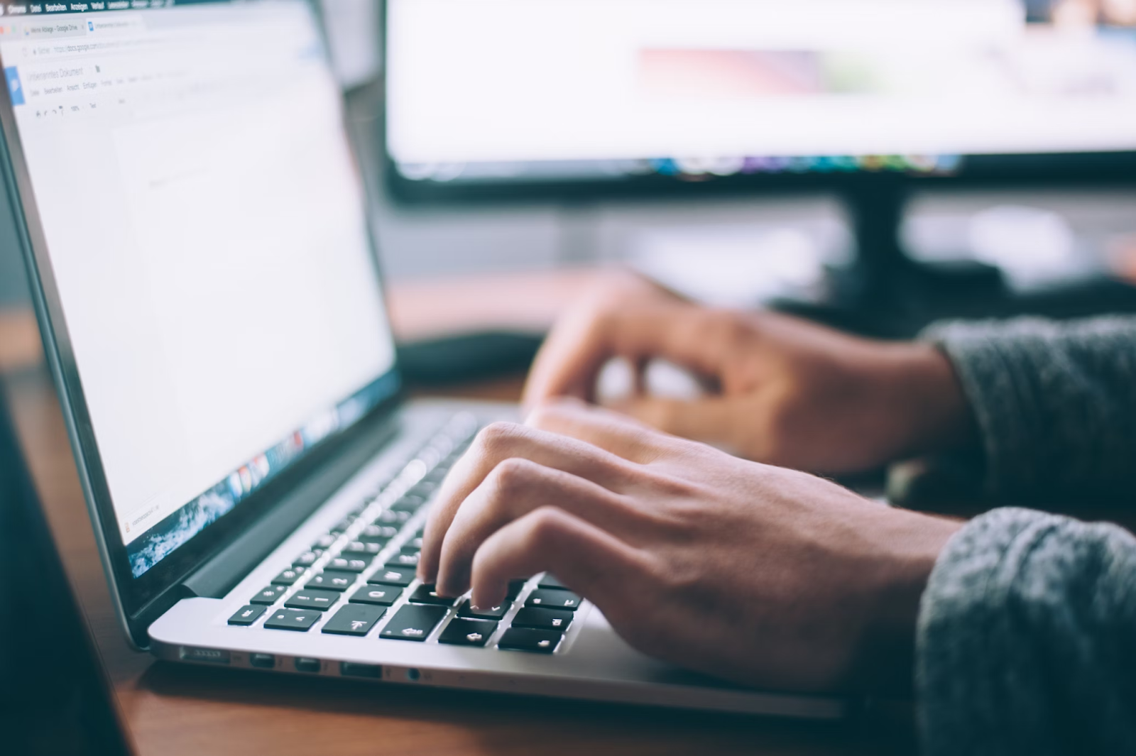 A person typing on a laptop. 