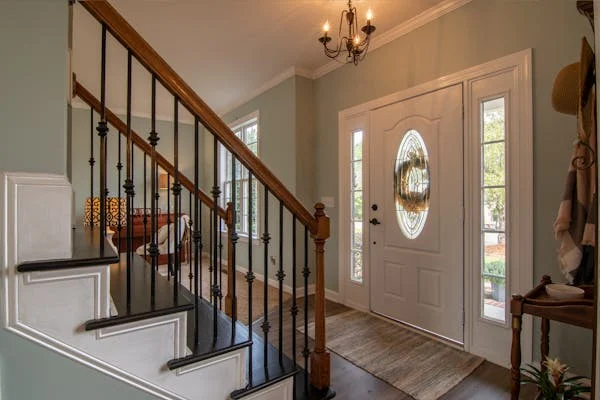 A beautiful staircase near the front door entry way of a house