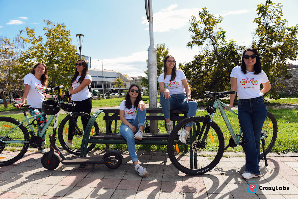 A group of women sitting on a bench with bicycles

Description automatically generated