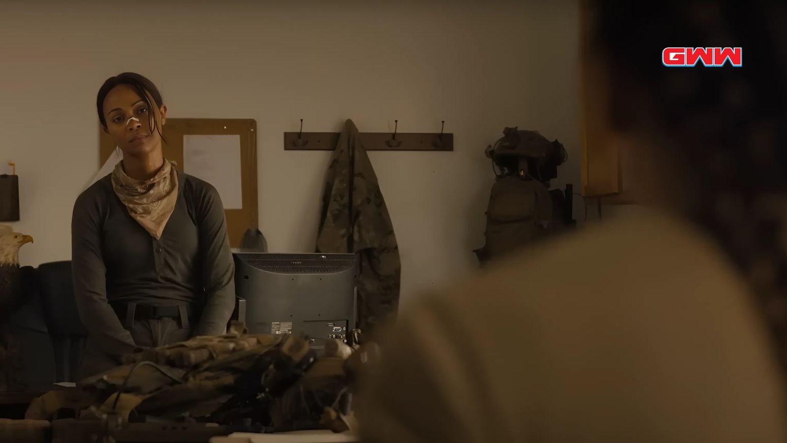 Zoe Saldaña as Joe in military attire, preparing for an operation.