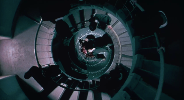 A group of people standing on a spiral staircaseDescription automatically generated