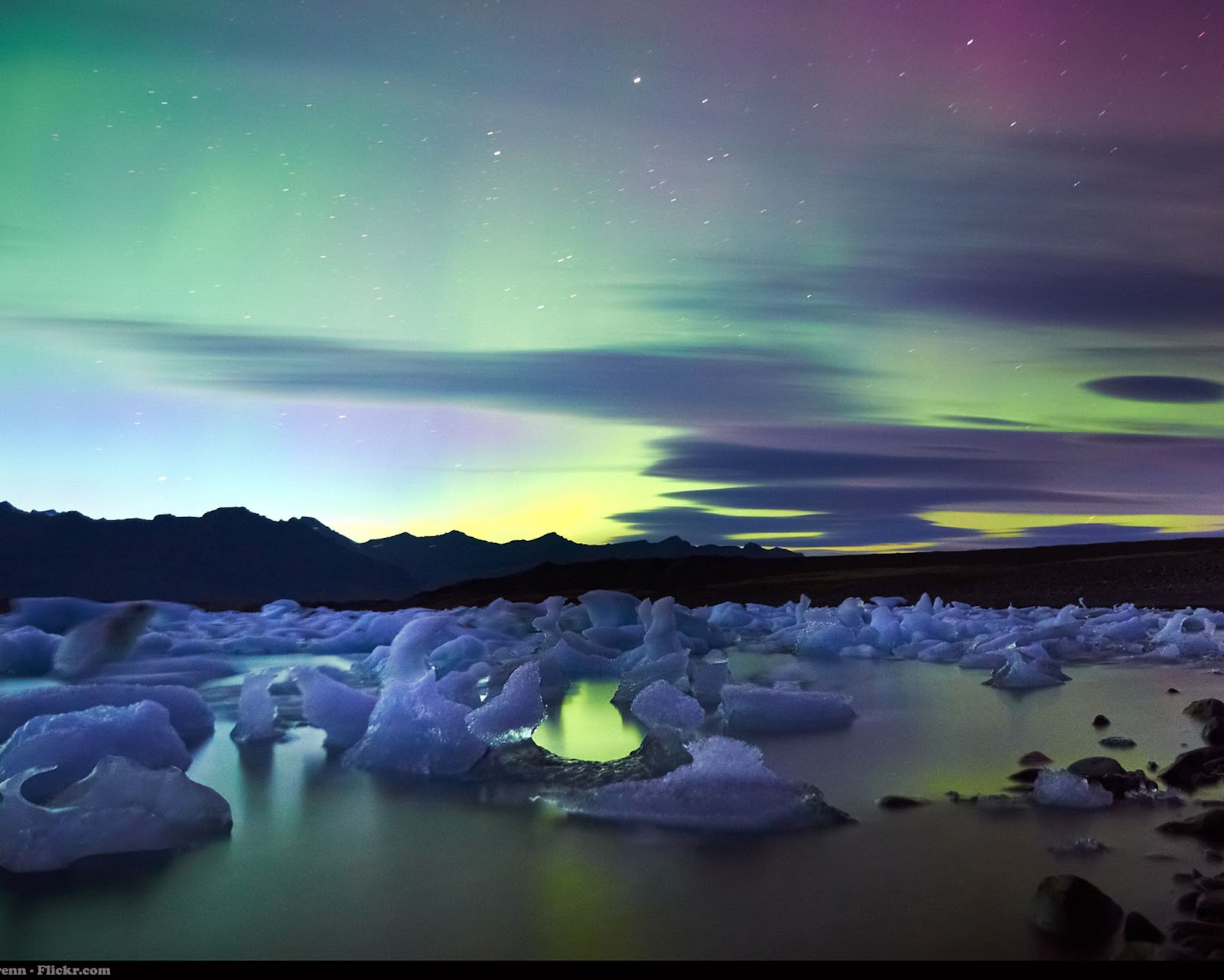 Northern lights over icy waters in Iceland.