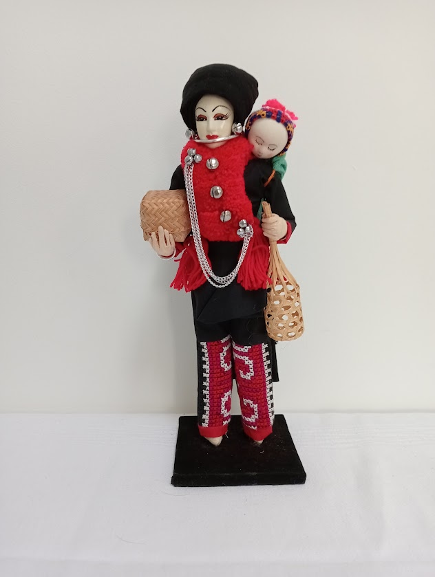 A doll of an Iu Mien woman and her baby