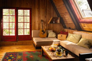 design tips for remodeling your northern michigan vacation rental cabin living room with large windows and couches custom built michigan