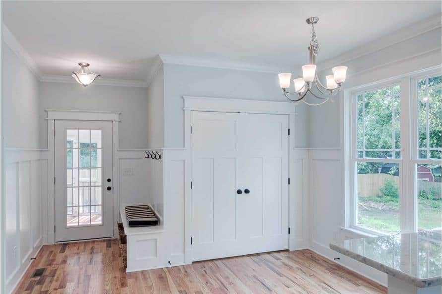 Mudroom with a built-in bench and a glazed door that leads to the screened porch.
