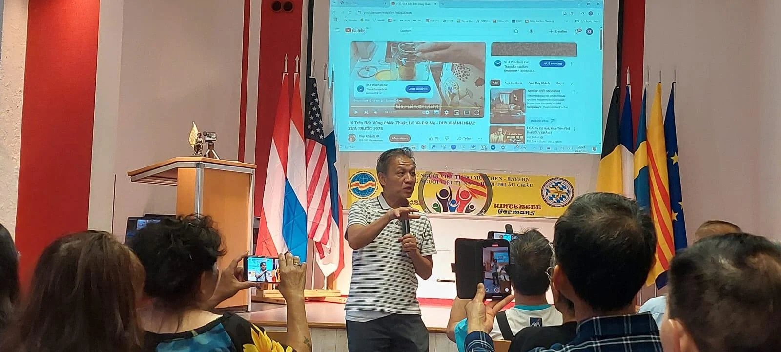 A person standing in front of a crowd of people

AI-generated content may be incorrect.