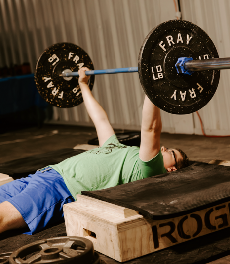 A person lifting weights on a bench

Description automatically generated