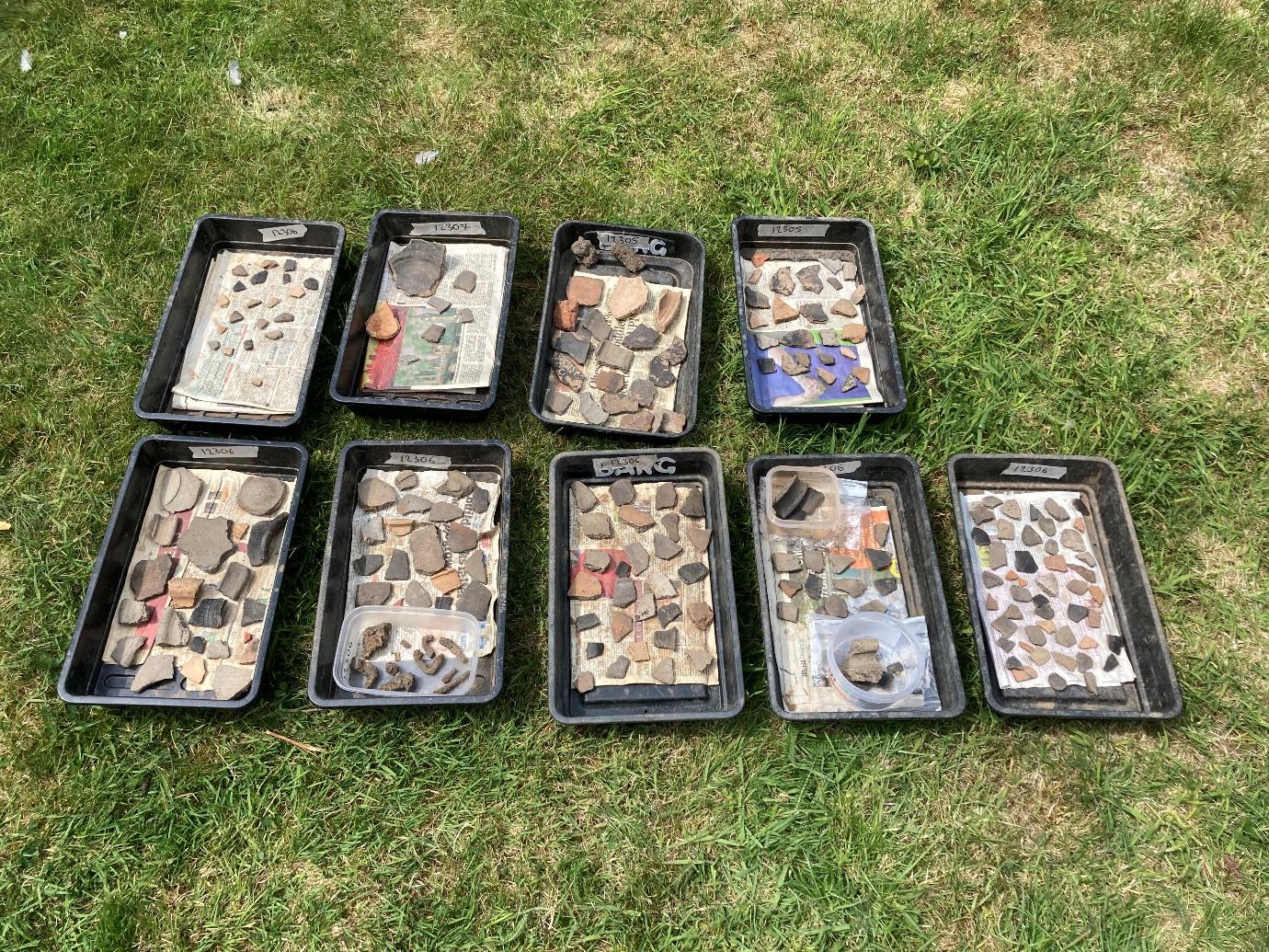 A group of black trays with rocks in them

AI-generated content may be incorrect.