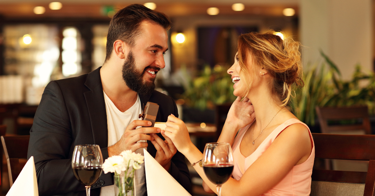 Man proposing to a woman during a beautiful dinner