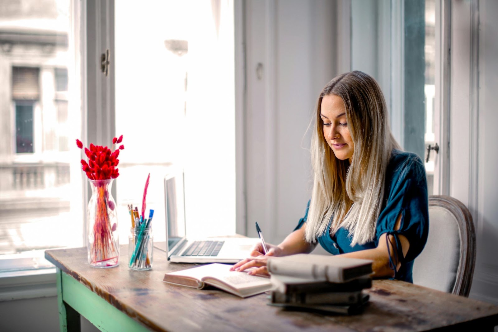 Woman Reading Book Within a Home Office