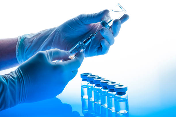 a-gloved-hand-drawing-liquid-from-a-vial-with-a-syringe-next-to-multiple-vaccine-vials-on-a-blue-reflective-surface-running-sarms-without-vesilute-youre-just-asking-for-a-heart-attack-tony-huge