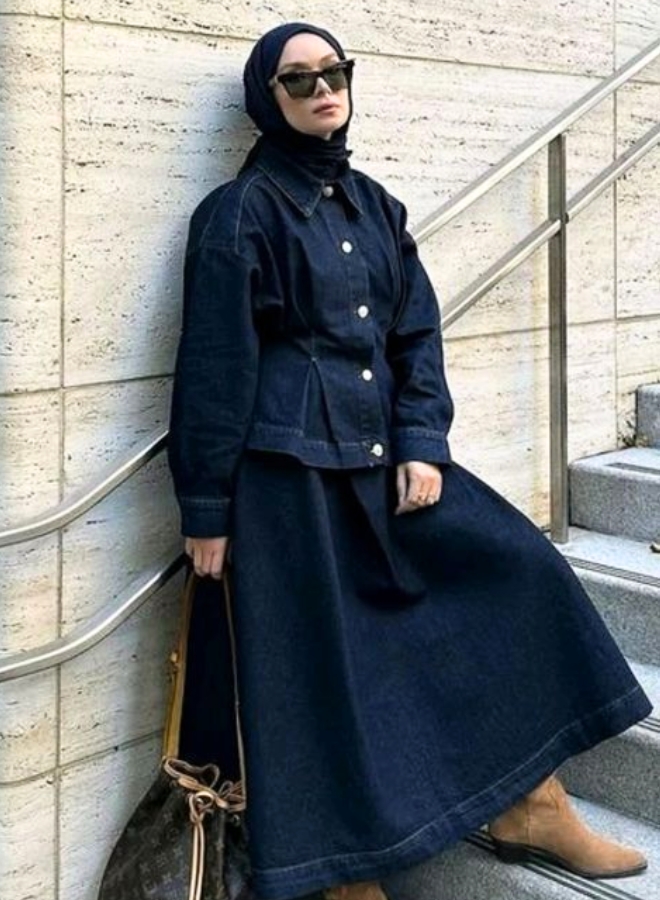 Wanita dengan gamis dan kerudung navy.