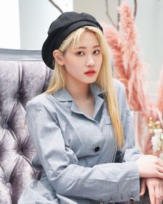 This  contain an image of Hyerim sitting in a chair with a hat on her head and long blonde hair