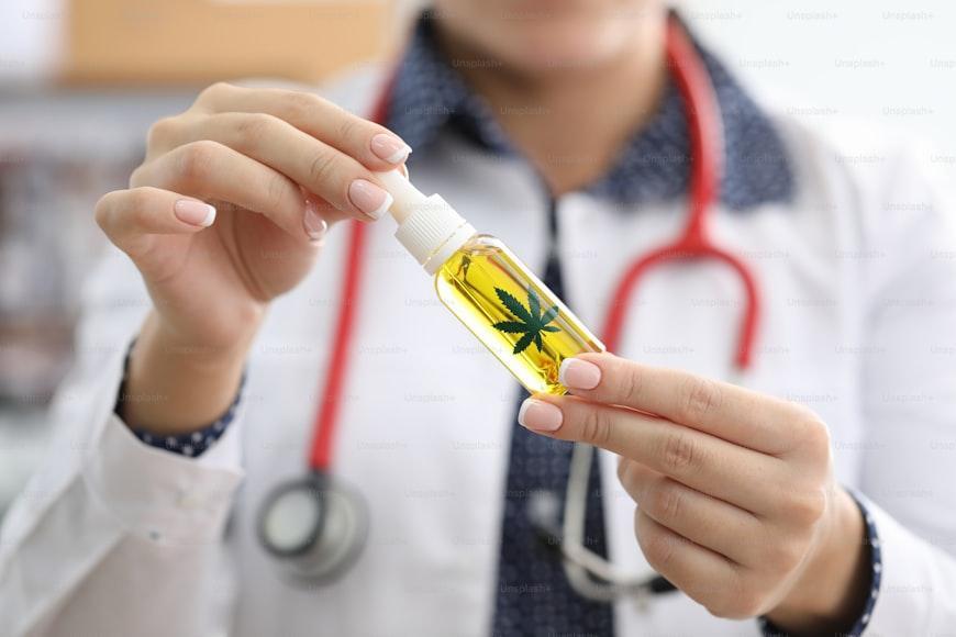 doctor showing an infused weed oil to patient