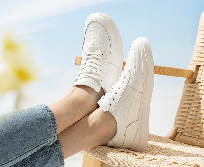 A pair of clean white sneakers styled with casual spring fashion ideas, adding a sporty yet chic touch.