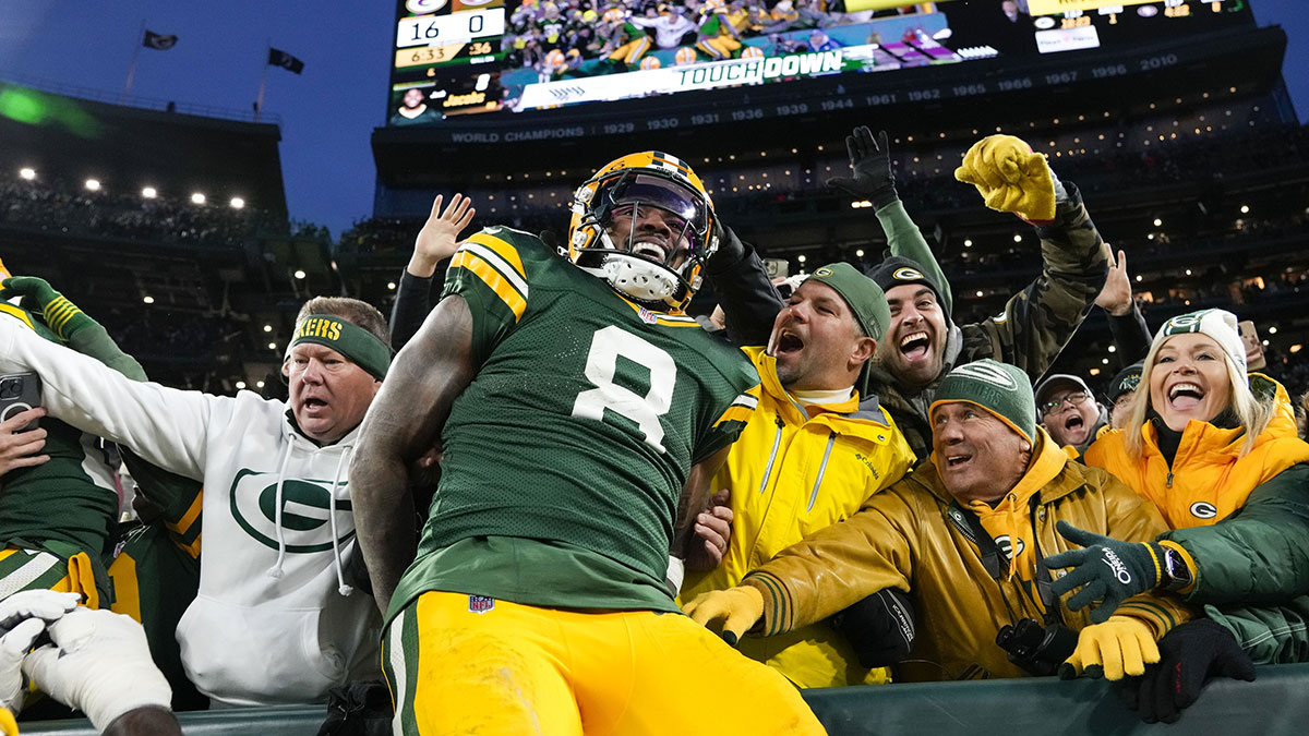 Green Bay Packers running back Josh Jacobs (8) celebrates after scoring a touchdown during the second quarter against the San Francisco 49ers at Lambeau Field. 