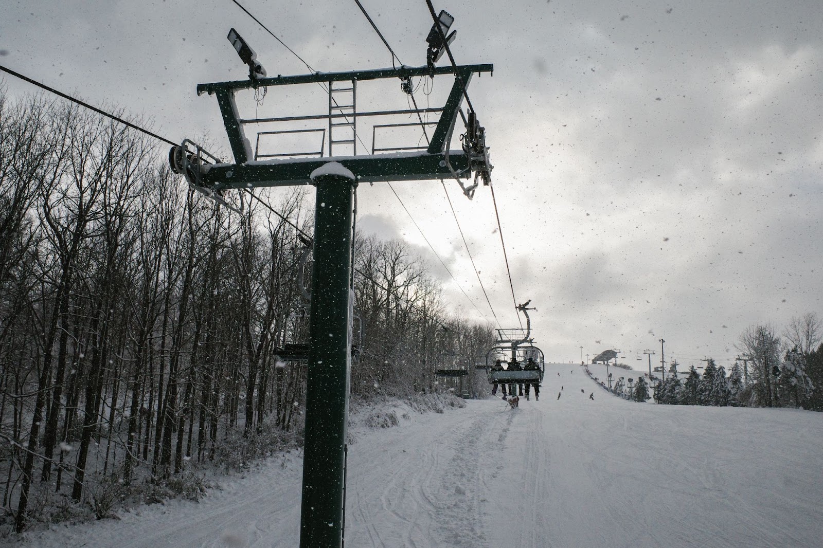 Snowy scene at ski resort with chairlift