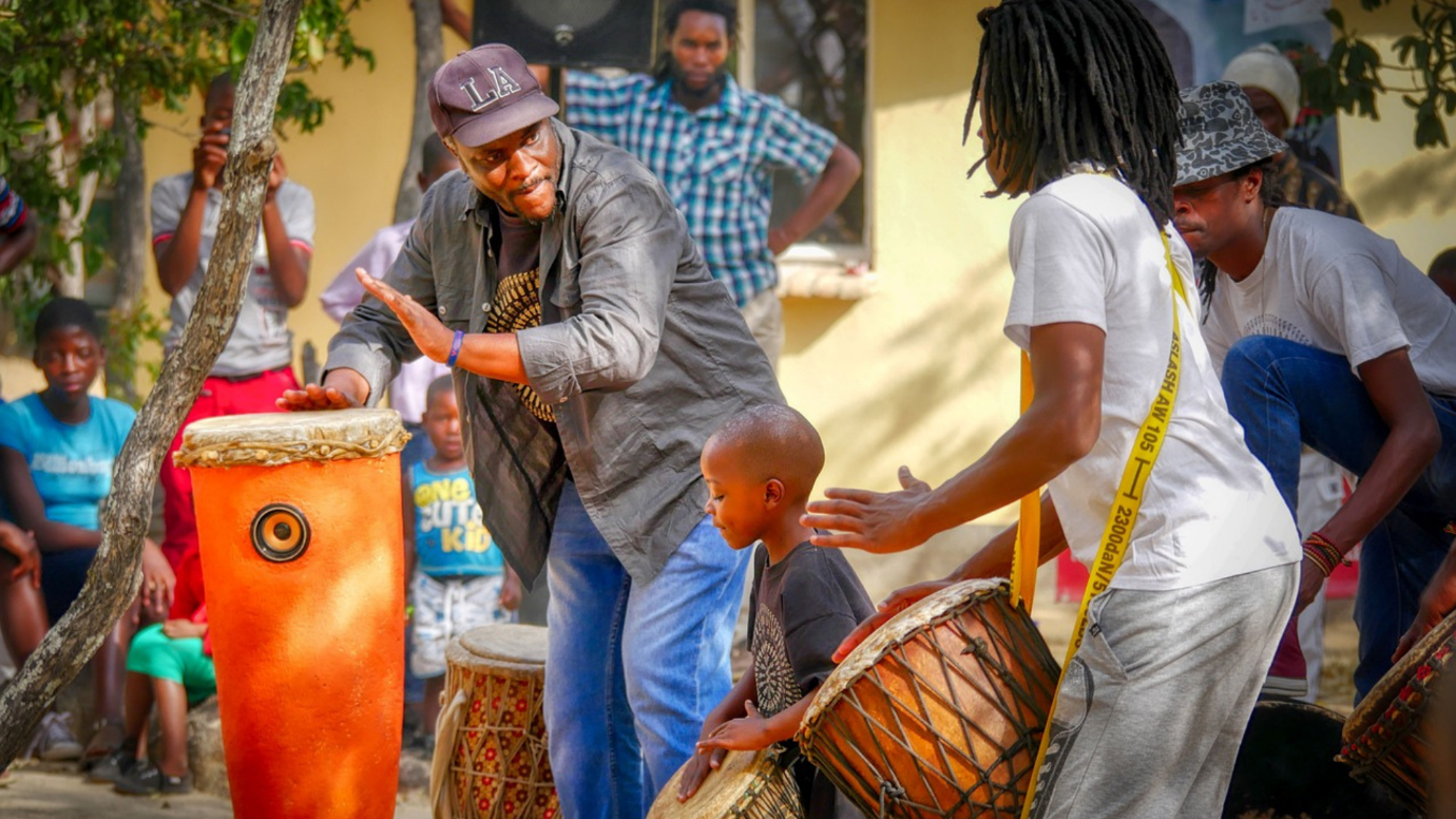 A group of people playing drums

Description automatically generated